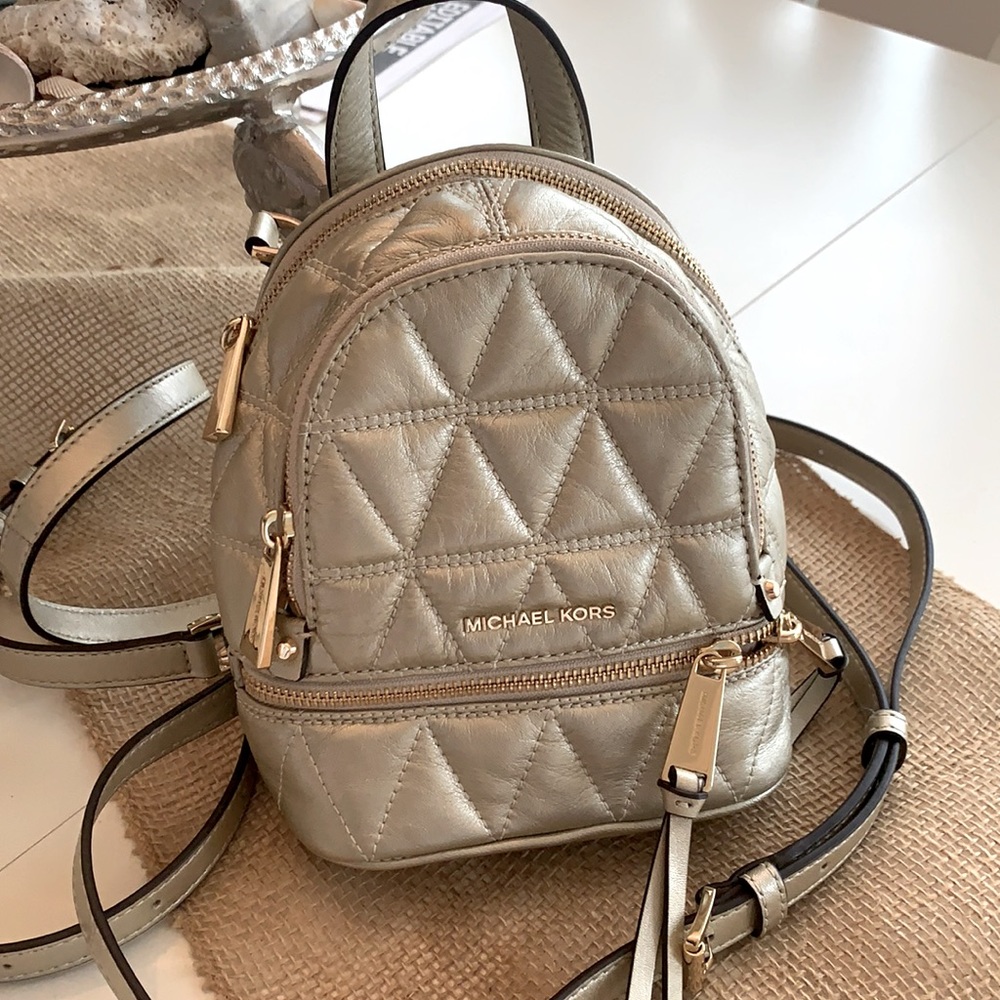 Like new  Michael Kors small gold backpack